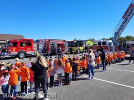 Pictured: FF A. Baldosaro teaches students how to "Stop, Drop, and Roll" 